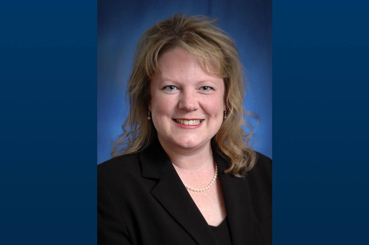 Portrait photo of woman with shoulder length hair and black blazer